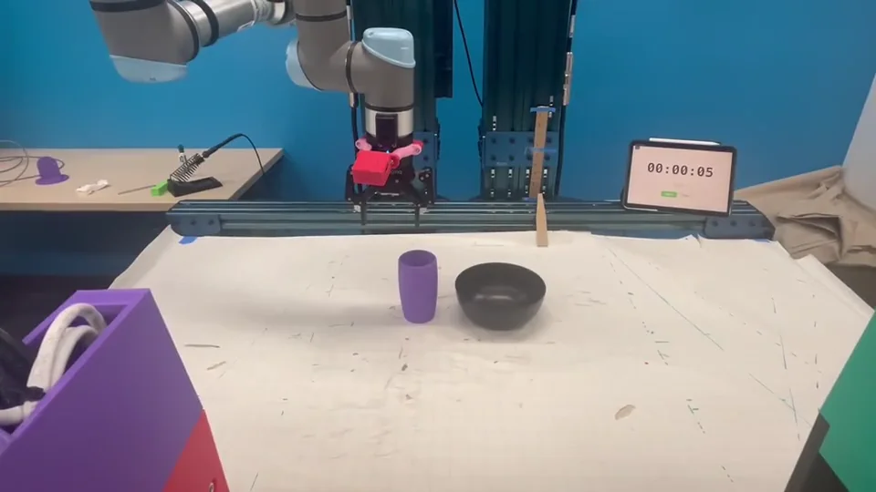 Real robot demonstration of the Cup tabletop pick-and-place task.
